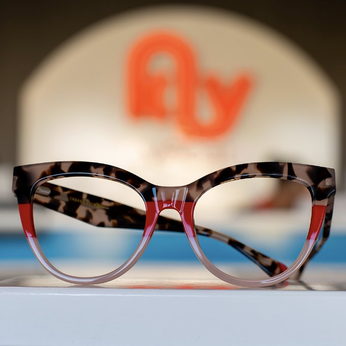 Tortoiseshell frames in front of the KLY logo