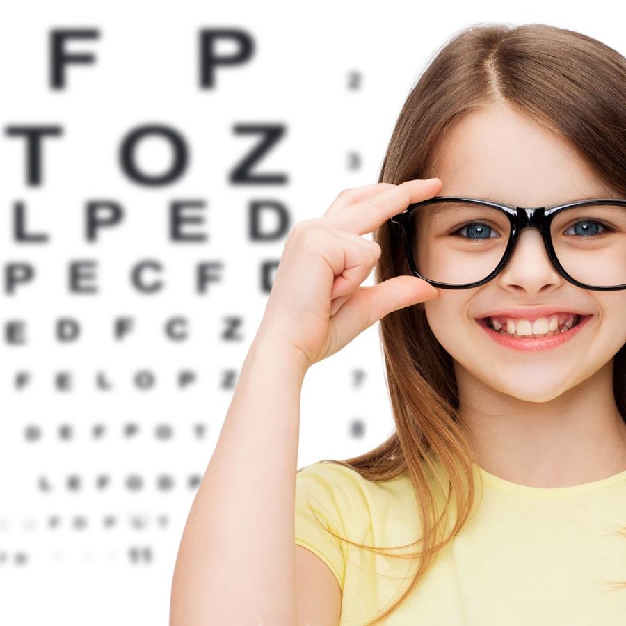Girl in glasses in front of an eye chart