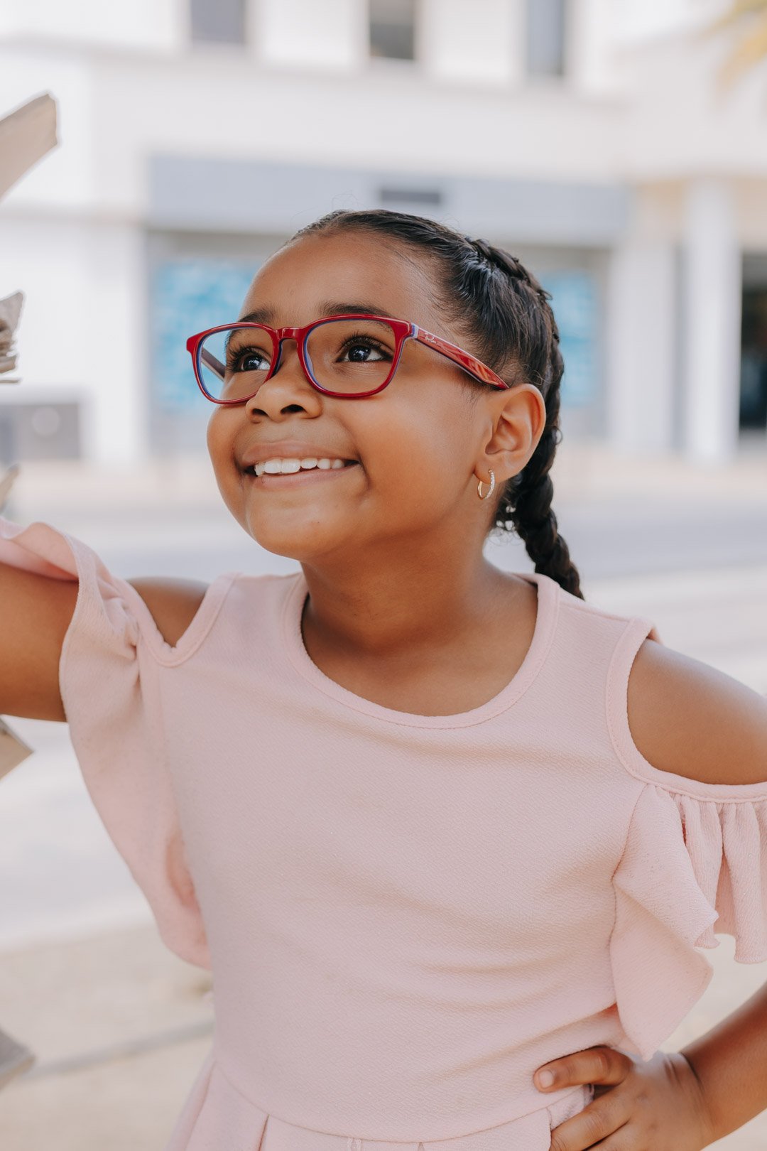 Smiling girl wearing red frames